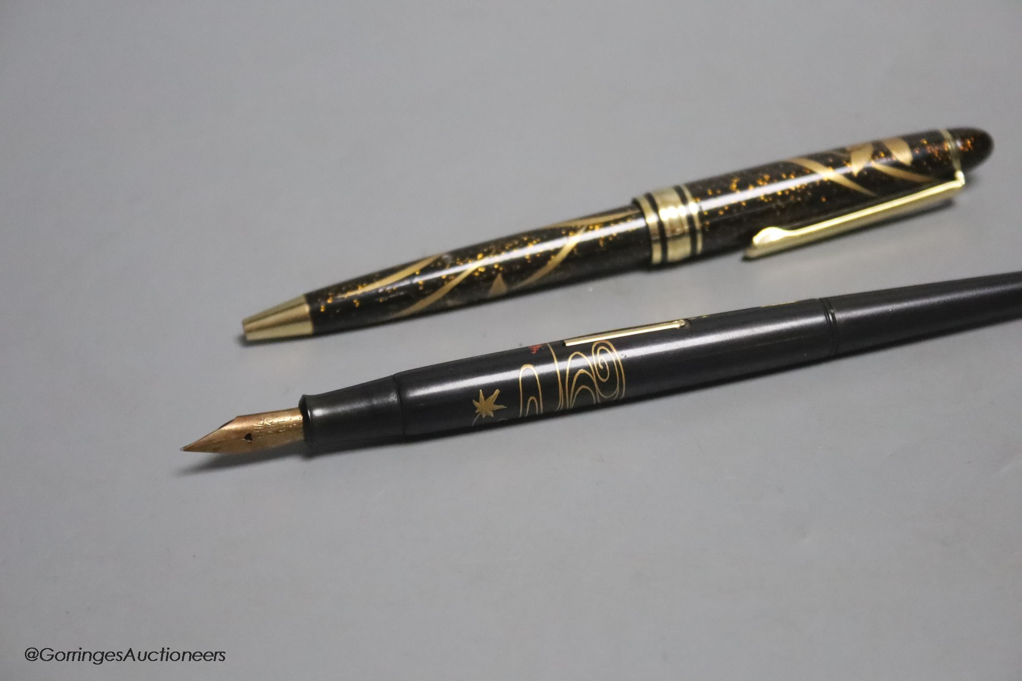 A Japanese lacquer maki-e dip style fountain pen with Dunhill Namiki nib, and a maki-e ballpoint pen